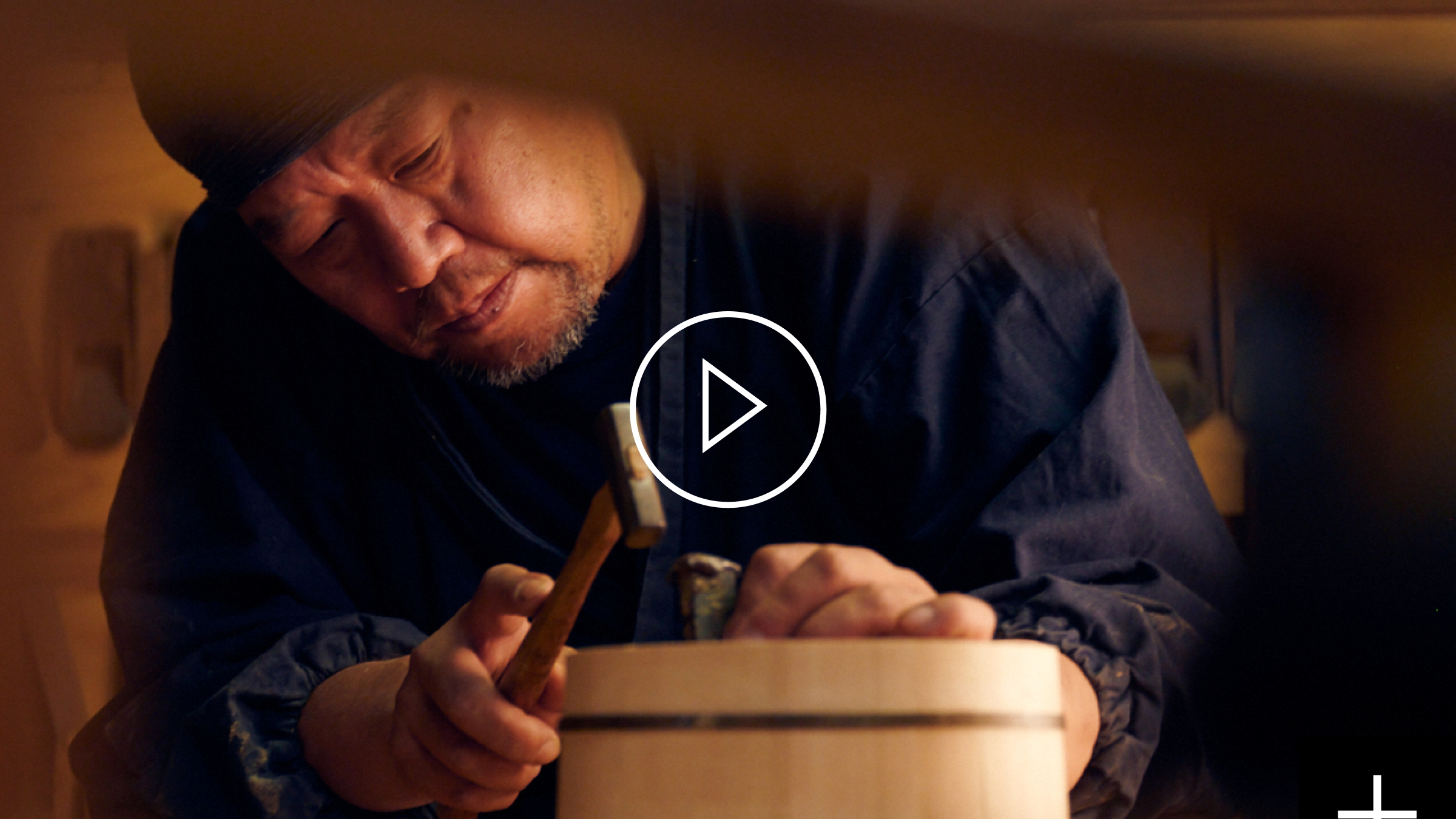 A Japanese craftsman hammering a wooden bowl in Kyoto.