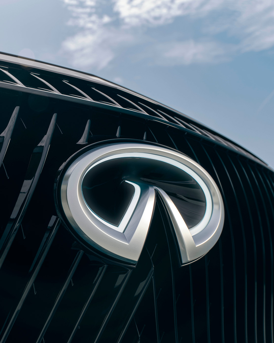 Close-up view of the INFINITI logo on the front grille