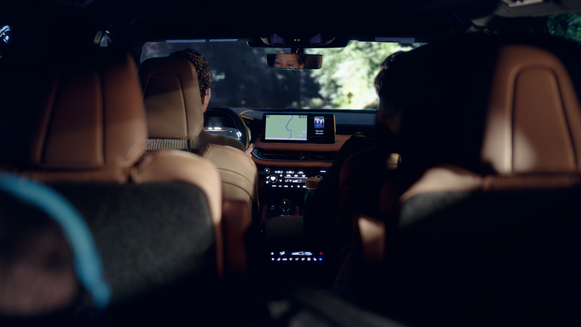 Interior view of a family driving in their 2024 INFINITI QX60 3-row SUV