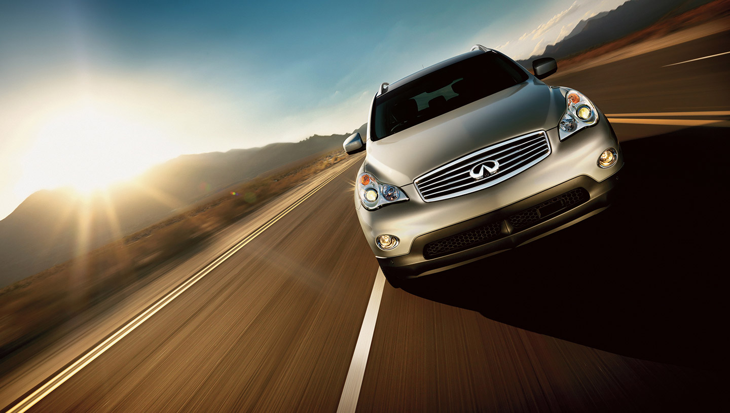 Front view of a silver grey INFINITI EX35 compact luxury SUV driving fast