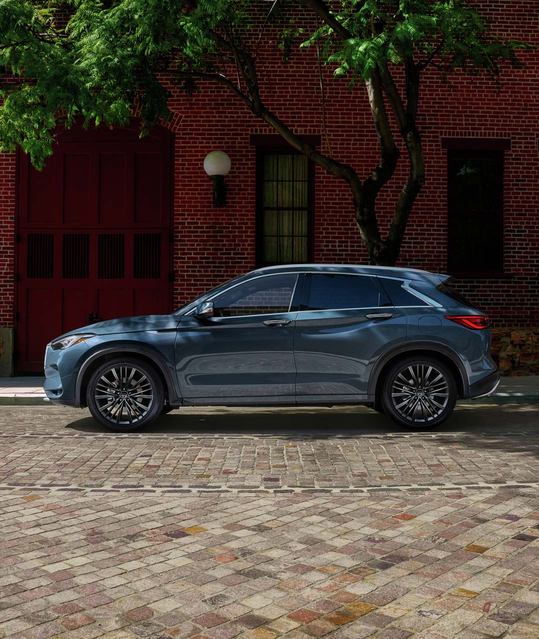 2024 INFINITI QX50 compact SUV in dark blue parked on the street