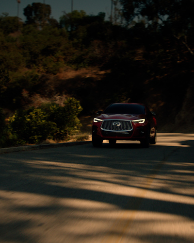 Front view of a red 2024 INFINITI QX55 crossover coupe with all-wheel drive