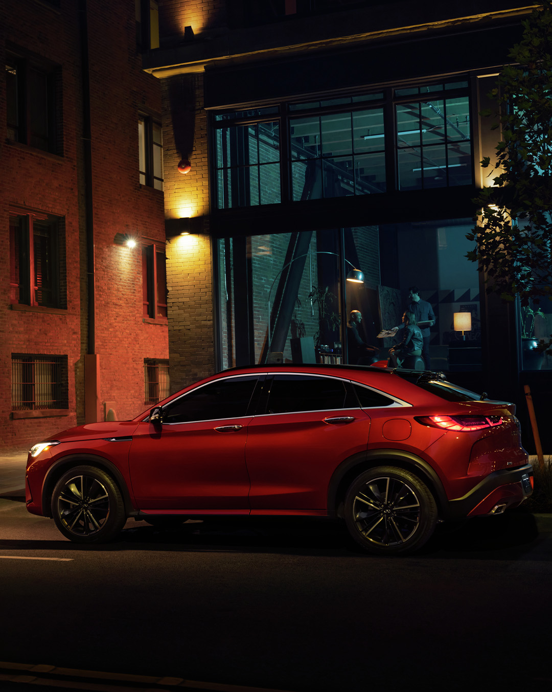 A red 2024 INFINITI QX55 crossover coupe parked on the street