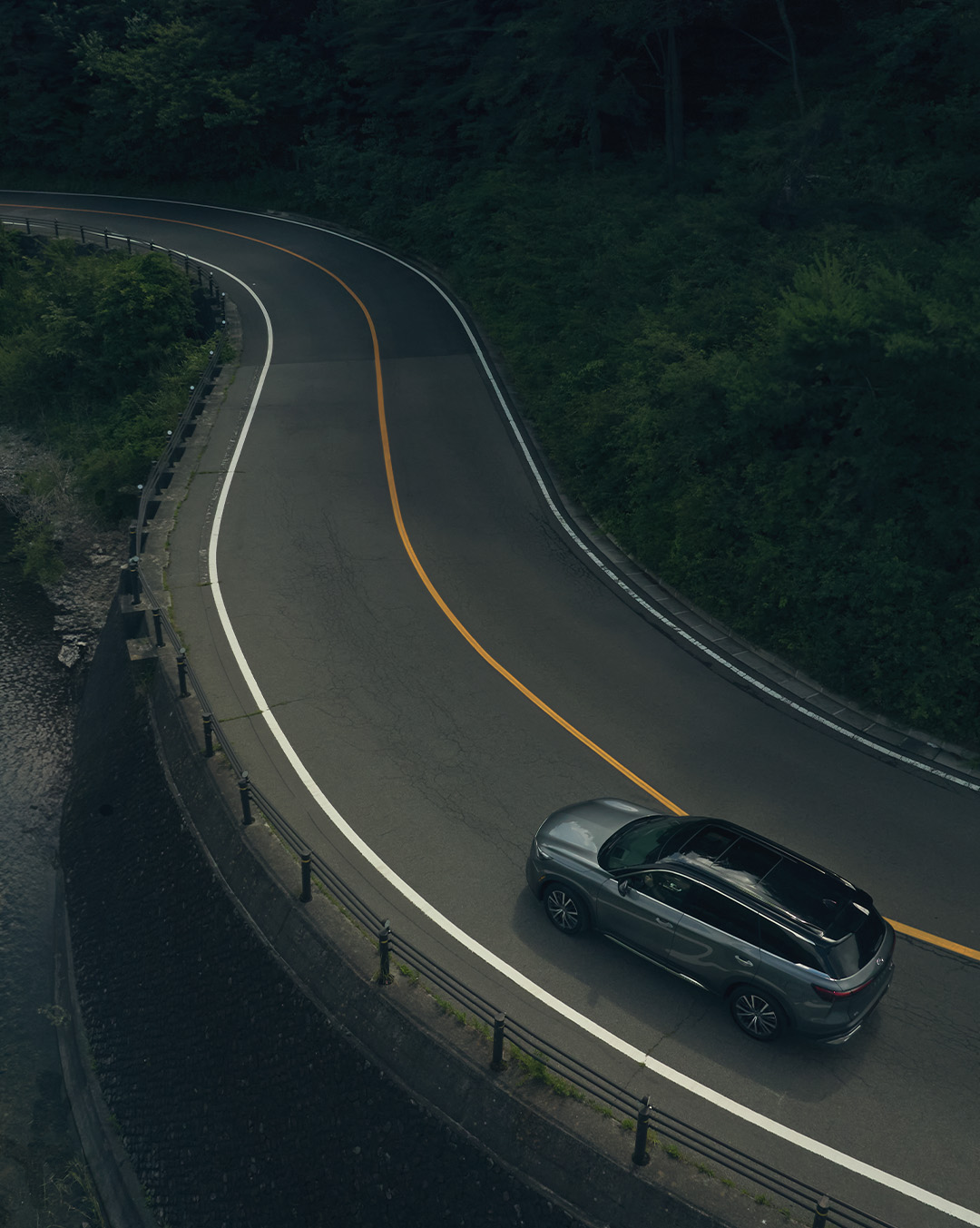 Overhead view of a 2024 INFINITI QX60 SUV driving on a highway