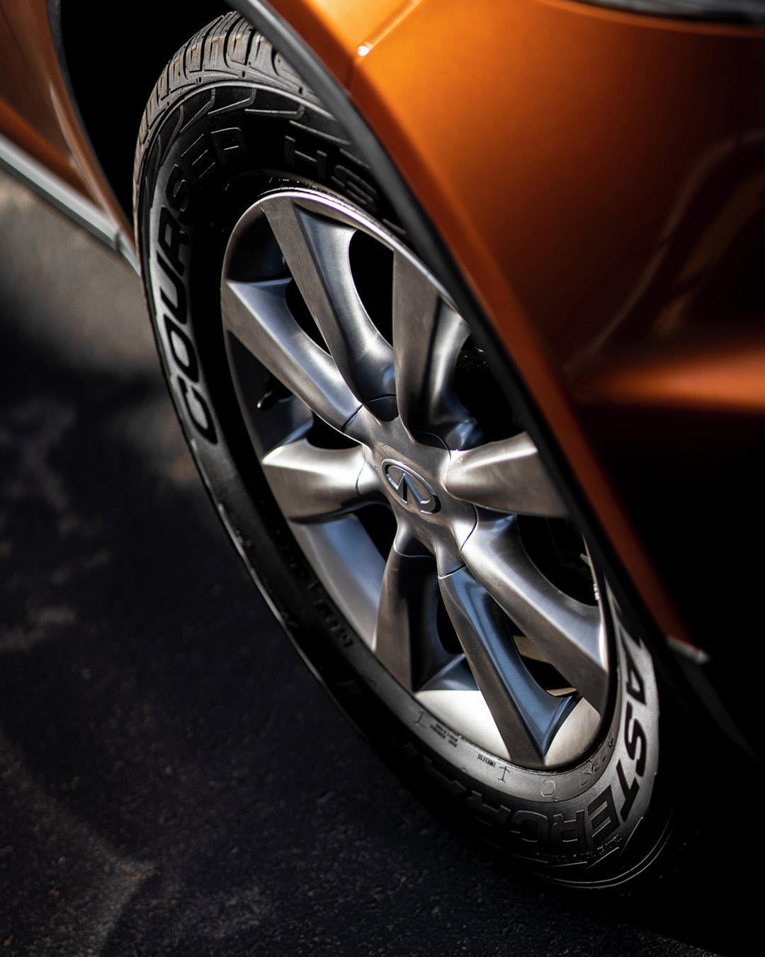Side profile of an orange 2003 INFINITI FX35 crossover coupe